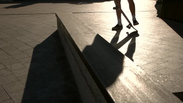 Feet standing on skateboard. Shadow of a skateboarder. Feeling of balance. I choose sports.