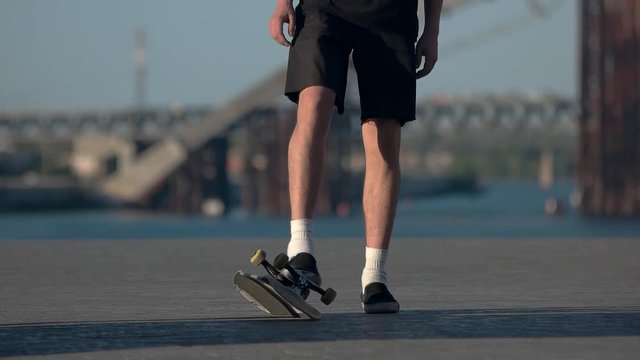 Person standing near skateboard. Skater wearing shorts. Don't let it slip away. Confidence and stubbornness.