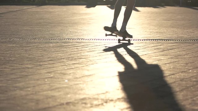 Legs riding skateboard. Skateboarder does trick in slow-mo. 360 spin tutorial. Speed and balance.