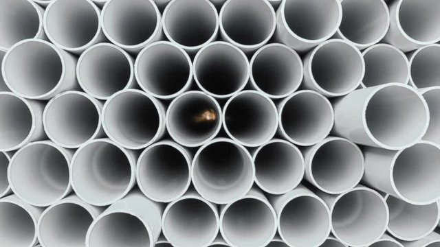 PVC pipes stacked in warehouse.