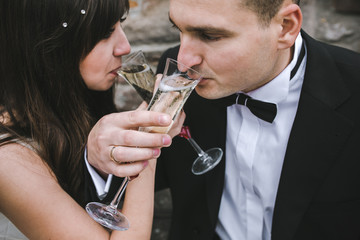 Beautiful wedding couple drinking champagne