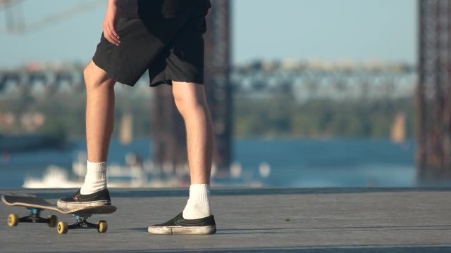 Legs performing a skate trick. Person with skateboard outdoor. Need to improve my skills. Talent and stubbornness.