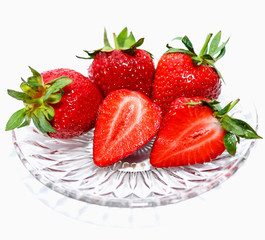 Fresh red strawberries in a glass dish with isolation on a white background.