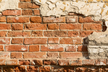 Crumbling wall of red brick