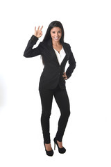 corporate portrait of young attractive latin businesswoman in office suit smiling happy