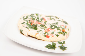 Omelette with tomatoes, fresh spinach and parsley