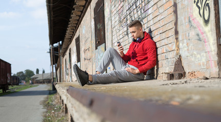 Running man outdoor using his smartphone