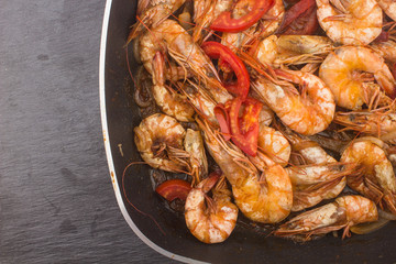 Cooked Fresh Shrimp with Tomato and Onions / Cooked Fresh Shrimp with Tomato and Onions Served in a plate on a Wooden ( Black Ceramic) background