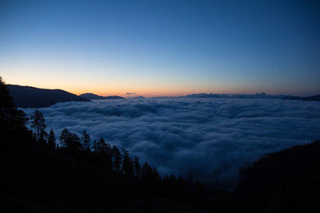 Fototapeta premium Sunrise On The Way To Gmeineck 2.592m With Clouds Above The Valley In Autumn In Carinthia Austria