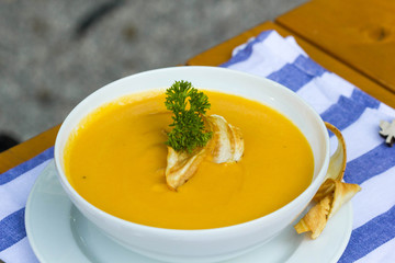 Carrot soup served in a garden. 