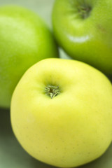Three green apples on dish