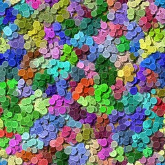a lot of full spectrum multi colored vintage clothing plastic buttons randomly scattered on the background - top view