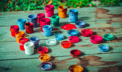 paint jars on a wooden surface