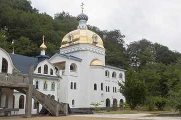 Fototapeta na wymiar Temple of the Icon of Our Lady of the Most Holy Mother Superior of Mount Athos in the Trinity-Georgievsky female monastery in village Lesnoye, Adler district Krasnodar region, Russia