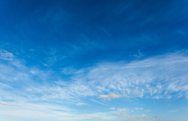 Naklejka na ściany i meble Blue sky with air white clouds. Beautiful heavenly background.
