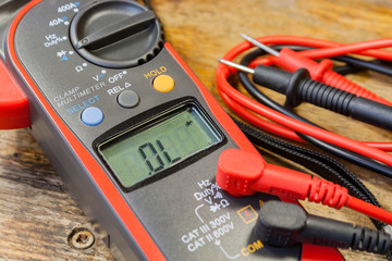 Clamp multimeter with accessories on a table in a workshop