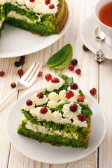 Spinach cake with cream and cranberries.