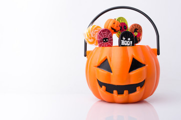 Orange pumpkin with colorful candies for Halloween party - Powered by Adobe