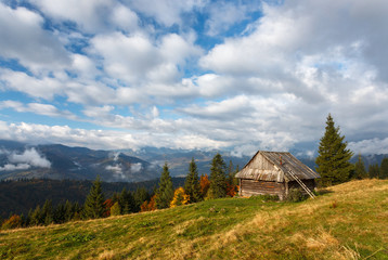 Landscape. Autumn day in the mountains. Carpathians. House in the valley.