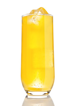 Glass of orange soda with ice cubes and bubbles