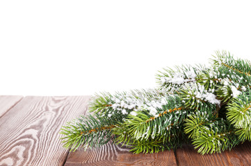 Christmas tree branch on wooden table