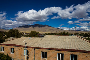 house mountain and clouds on the blue sky
