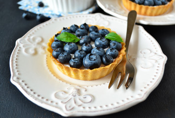Tartlets with meringue and strawberries, festive table