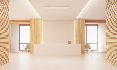 Fototapeta na wymiar Close up of sunlit reception desk in light wood corridor