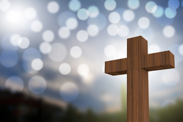 3D rendering of wooden cross on a blue sky with sunlight and bok