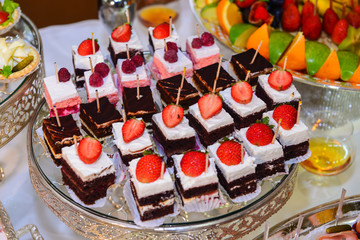 Delicious mini cakes with lemon, strawberry and rasberry