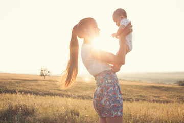 Epic Portrait of mother and baby on sunset outdoors