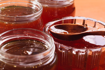 Honey in jars, a wooden spoon with honey