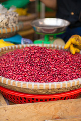 Texture of raw red bean selling on interwoven bamboo basket in fresh local market, Vietnam