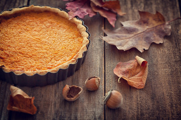 Thanksgiving pumpkin pie on wooden background 