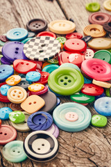 Buttons on wooden background
