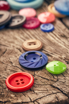 Buttons on wooden background