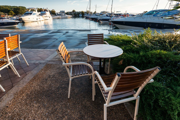 Cafe near the marina with yachts  at sunset, Greece