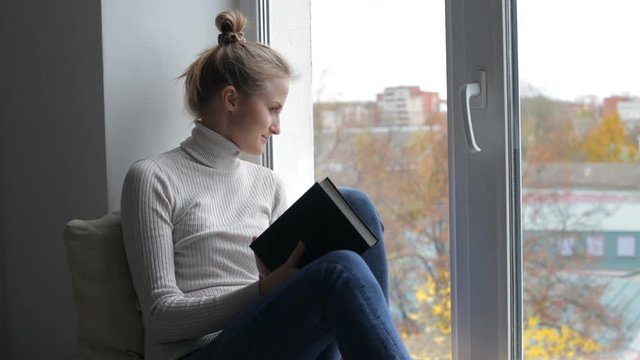 Blond woman reading book