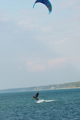 Water sport, kiteboarding on Lake Michigan in warm fall day