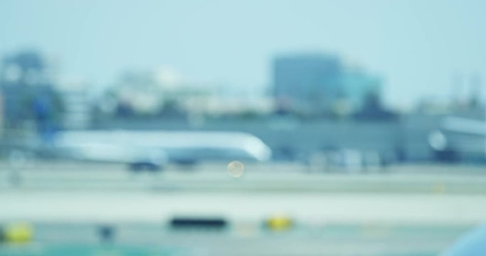 Soft focus video of plane moving down runway at airport