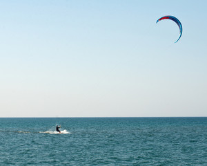 Water sport, kiteboarding on Lake Michigan in warm fall day