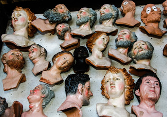 many terracotta heads for sheperds of nativity scenes, in the tradition of Neapolitan christmas,...