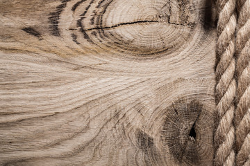 Vintage spirally twisted jute ropes on wooden board horizontal v