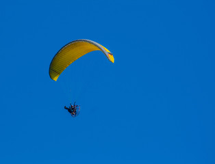 Yellow paragliding on flight