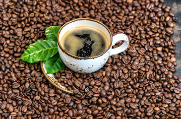 Black coffee drink green leaves coffee beans background