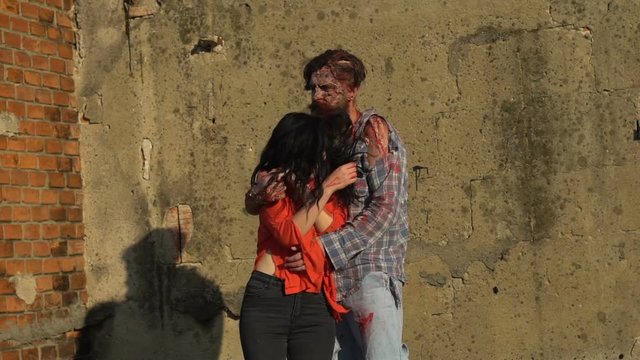 two zombies dance at sunset from the city walls