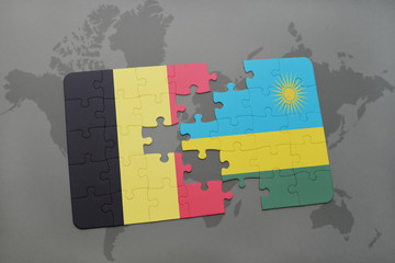 puzzle with the national flag of belgium and rwanda on a world map background.