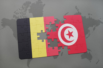 puzzle with the national flag of belgium and tunisia on a world map background.