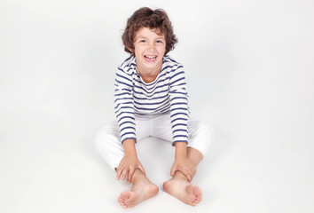Fototapeta premium Cute and funny little boy in stripe shirt and white jeans 
