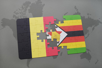 puzzle with the national flag of belgium and zimbabwe on a world map background.